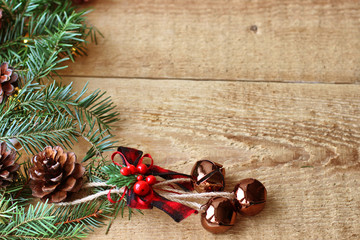 Christmas decorations - branches of coniferous trees with decorations on a wooden background.