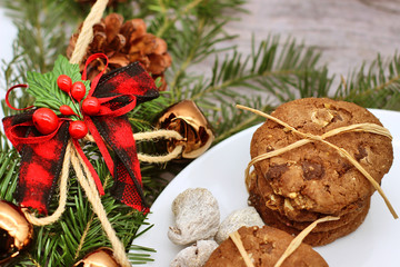 Christmas decorations - oat biscuits for Santa Claus and branches of coniferous trees