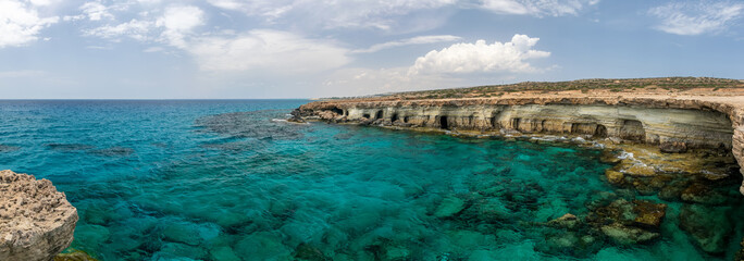 Fototapeta na wymiar Picturesque sea caves are located on the Mediterranean coast.