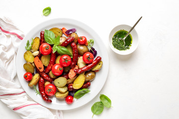 Sausages roasted with vegetables, view from above