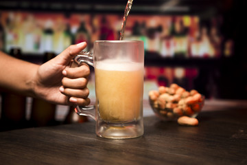 Hand holding beer glass