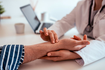 Checking patient's pulse, close-up.