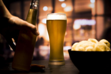 Beer glass in front of blurred background