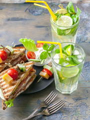 Delicious sandwiches and homemade lemonade. Drinks and snacks. Vertical shot