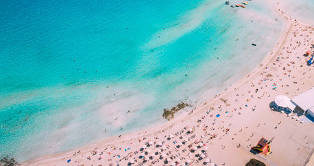 Beautiful beach on Mediterranean Sea with many tourists on sunny day, aerial
