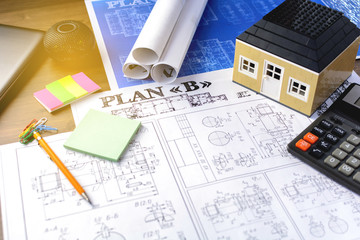 Business accessories, design and construction projects on the desktop with a miniature home