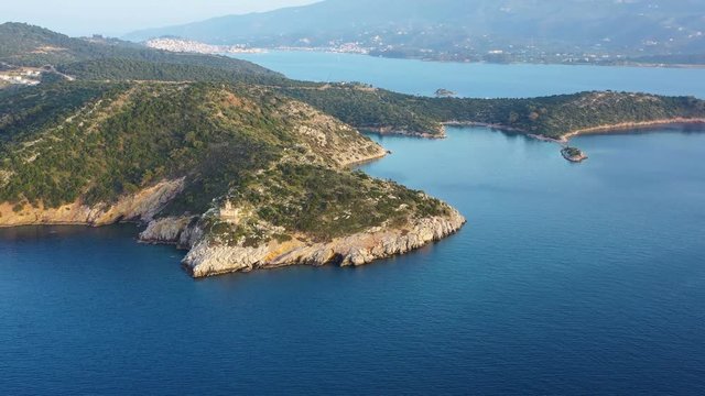 Beautiful Poros Greece Dana lighthouse. Sunset backlight. Greek islands on background. Aerial drone video footage. Evening sunset time