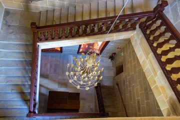 ancient chandelier and square staircase in the castle