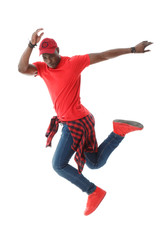 Young black stylish guy in red in a jump isolated on white background.