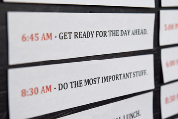 Close up making agenda Daily schedule on personal organizer. Business and entrepreneur concept. Isolated on black background
