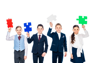 happy kids in formal wear holding puzzle pieces Isolated On White