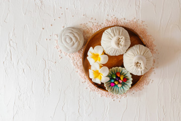 Top view of spa background with , towels, candle, .incense and, herbal compress balls.