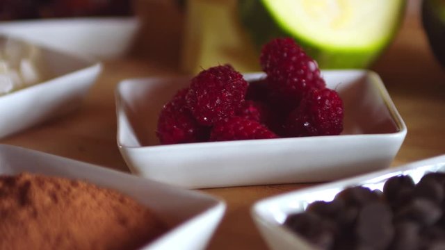 Ingredients to prepare a raw vegan dessert, presented on a wooden table