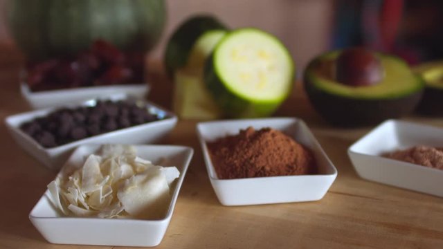 Ingredients to prepare a raw vegan dessert, presented on a wooden table