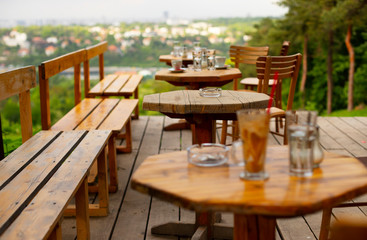 Tables in an empty cafe with a beautiful view of the city