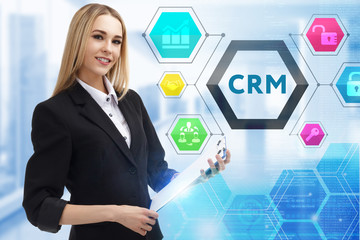 The concept of business, technology, the Internet and the network. A young entrepreneur working on a virtual screen of the future and sees the inscription: CRM