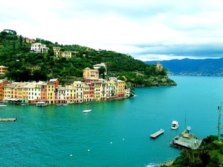 Fototapeta na wymiar PORTOFINO , ITALY - MAY 02, 2019: The beautiful Portofino with colorful houses and villas, luxury yachts and boats in little bay harbor. Liguria, Italy, Europe