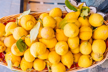Wicker basket full of lemons on the italian street od Corniglia