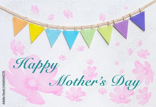 Happy mother's day on white wall with pink flower pattern and colorful party flag