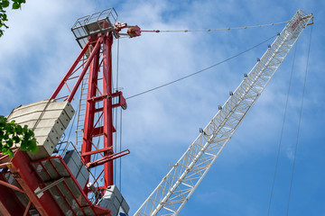 construction crane on building site on blue sky background bottom view