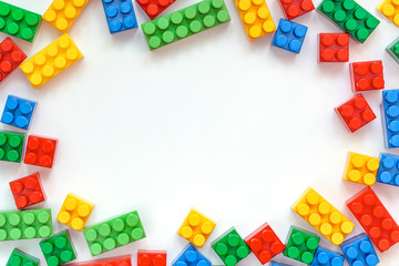 Educational toys for kids mockup, top view. Colorful plastic Bricks on white background. copy space. concept of education, children's creativity