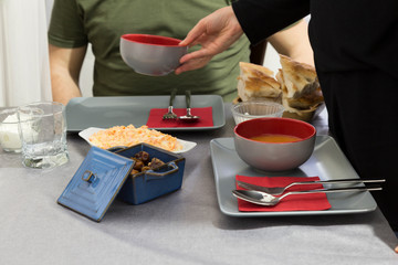 very nicely prepared dining table for special, valentines' day or Ramadan or Christmas in the luxury living room. soup,bread,salads on the table for party time.