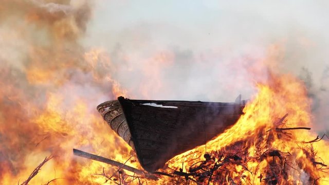 Valborg, Walpurgis Eve or night greeted with bonfire in Sweden, burning old wooden boat on open campfire, Umea city