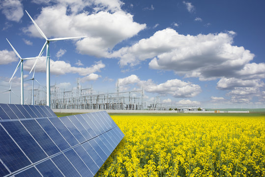 Green energy and transformer substation in a natural environment with blue sky and yellow rape field