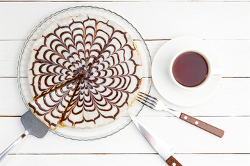 Homemade pie and cup of tea on white wooden table