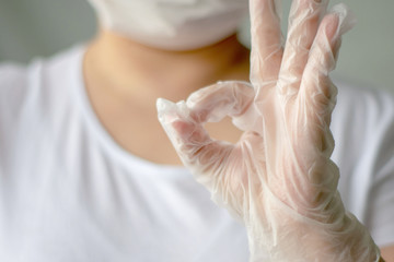 Naklejka premium Hand in white latex surgical glove. Hand gesture on white background