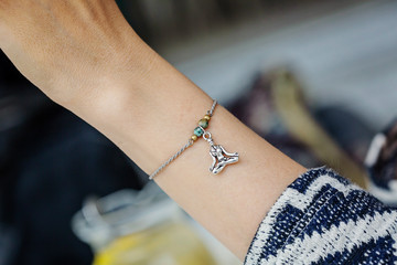 Female wrist wearing tiny jewelry bracelet with mineral stone beads