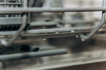 empty open dishwasher closeup. cutlery compartment close-up. household appliances in the kitchen macro