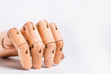A wooden orthopedic hand on white background.