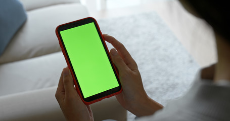 Woman hold cellphone with green screen