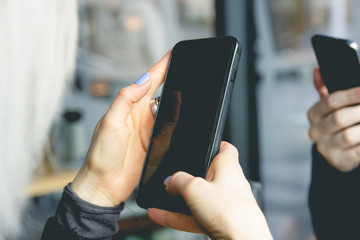 A pair of young people sitting in the phones.