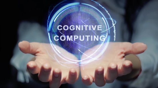 Female hands show a round conceptual hologram with text Cognitive computing. Unrecognizable woman in ashen white on a black background with future holographic technology