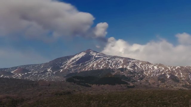 Aerial dolly view of mount Etna in Sicily with snow in winter