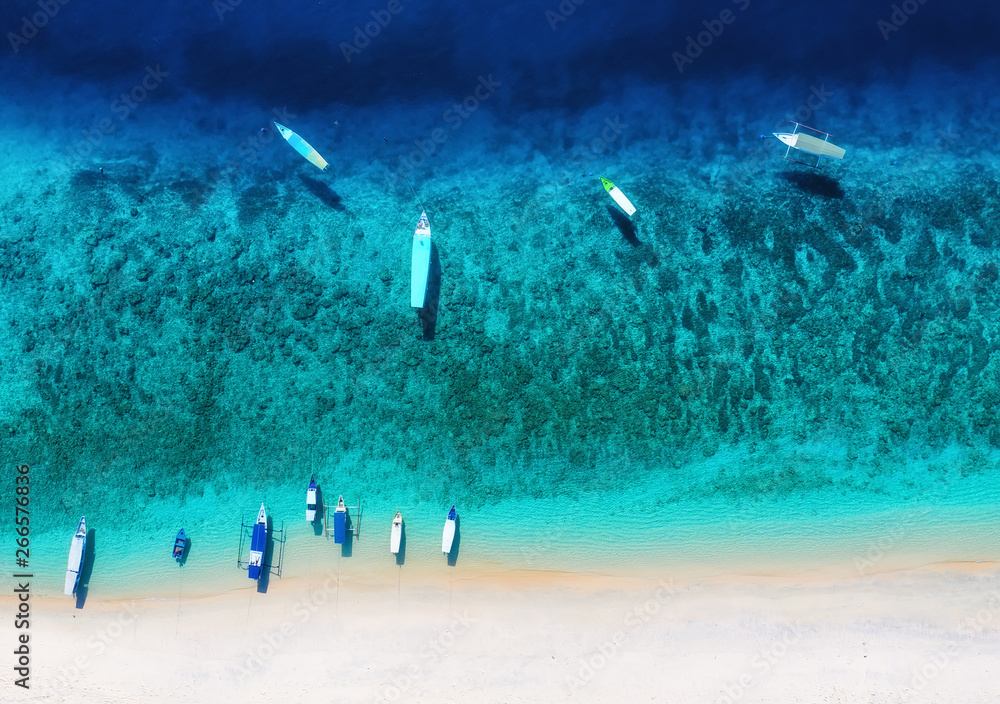 Wall mural boat on the water surface from top view. turquoise water background from top view. summer seascape f