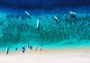 Boat on the water surface from top view. Turquoise water background from top view. Summer seascape...