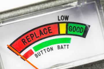 Battery tester macro close up detail of needle pointing towards replace.  