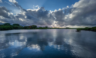 Panoramic view of a waterway with clouds reflection at dusk,  Poste de Flacq, Mauritius