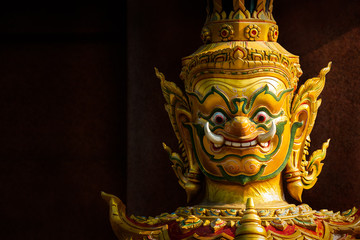 Giant statue, character in Thai fairy tale for public temple decoration on dark background with...