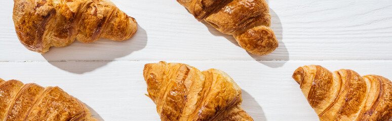 panoramic shot of delicious and sweet croissants on white surface