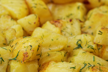 Sauteed potatoes with dill, close up background