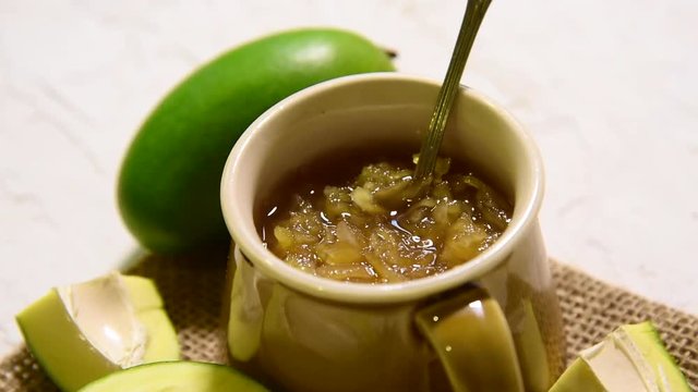 Mango Chunda or Sakhar Amba is a traditional indian summer recipe made using accha aam preserved in sugar syrup for days. selective focus