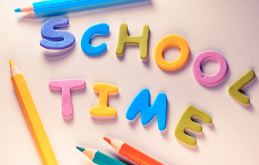 School time words over a kid's school desk. Suitable for back to school activities , The first day of classes, office or end of vacations or Kids concepts.