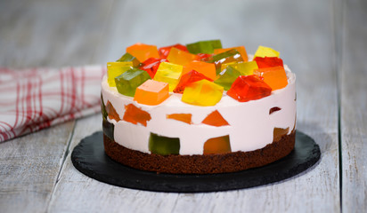 Homemade fruit dairy multi-colored jelly cake on a plate