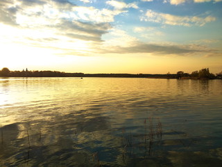 Obraz premium Sunset on the lake. Quiet summer evening. Calm smooth water. Beautiful multi-colored sky.
