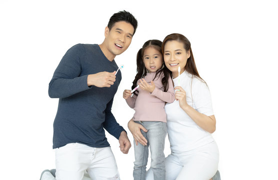 Portrait Of Smiling Happy Asian Family Brushing Teeth And Smiling At Camera Isolated On White.Healthy Teeth.