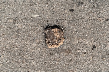 hole on asphalt road in countryside